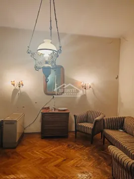 Living room with seating furniture and a classic chandelier. - image 4