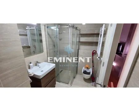 Modernly equipped bathroom with a shower cabin, washbasin, and toilet. - image 7