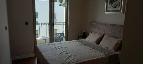 Furnished bedroom with a double bed and access to the terrace. - image 6