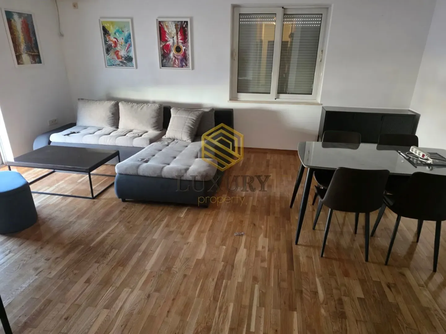 Living room with a sofa set and dining table.