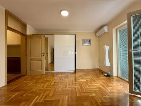 Bedroom with parquet flooring, built-in wardrobe, and access to the terrace. - image 12