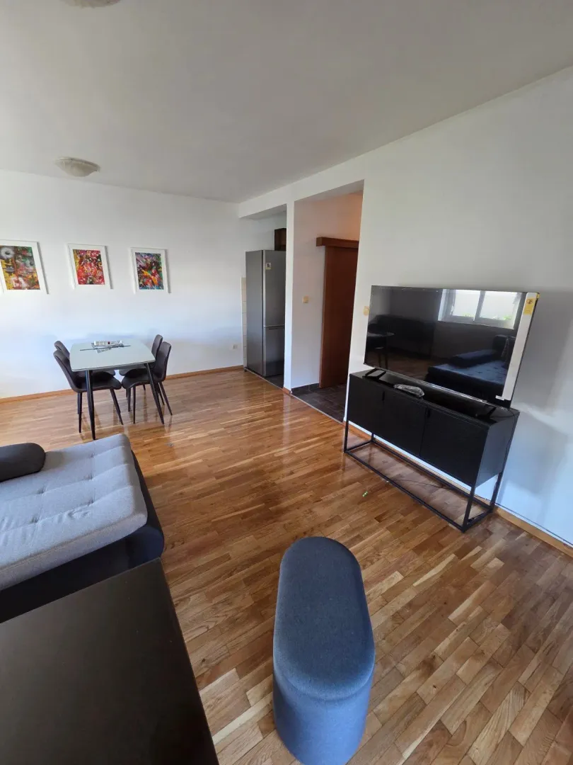 Spacious living room with a dining area and hardwood flooring.