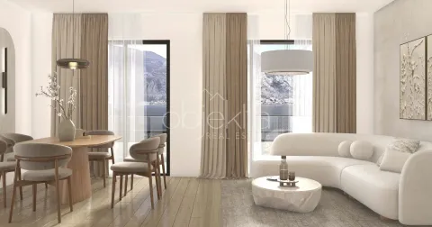 Living room with dining area and sea view through large windows. - image 6