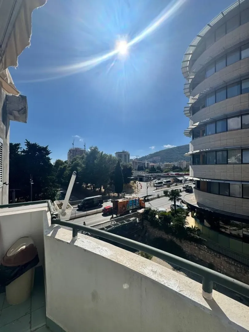 View from the balcony overlooking the city street and surrounding buildings.