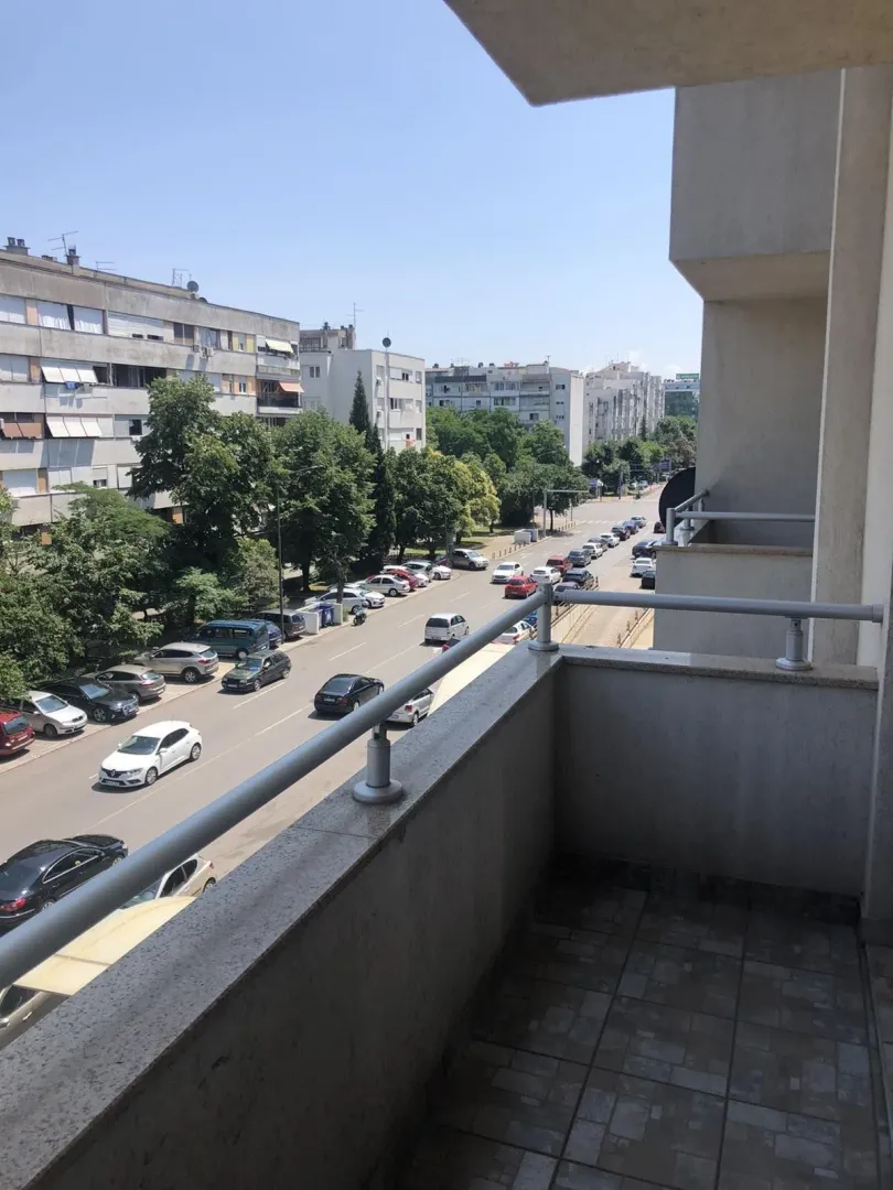 View from the balcony overlooking the street and buildings.