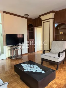 Living room with seating area, television, and wooden furniture. - image 6