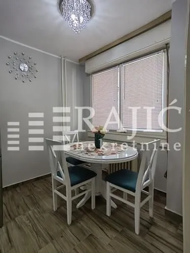 Dining area with a table, chairs, and window.