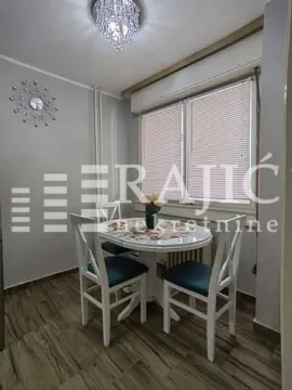 Dining area with a table, chairs, and window. - image 8