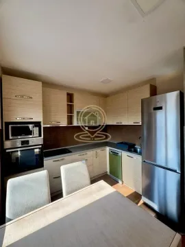 Equipped kitchen with wooden elements and a dining table. - image 7
