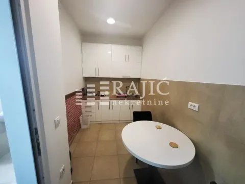 Smaller kitchen with a dining table. - image 11