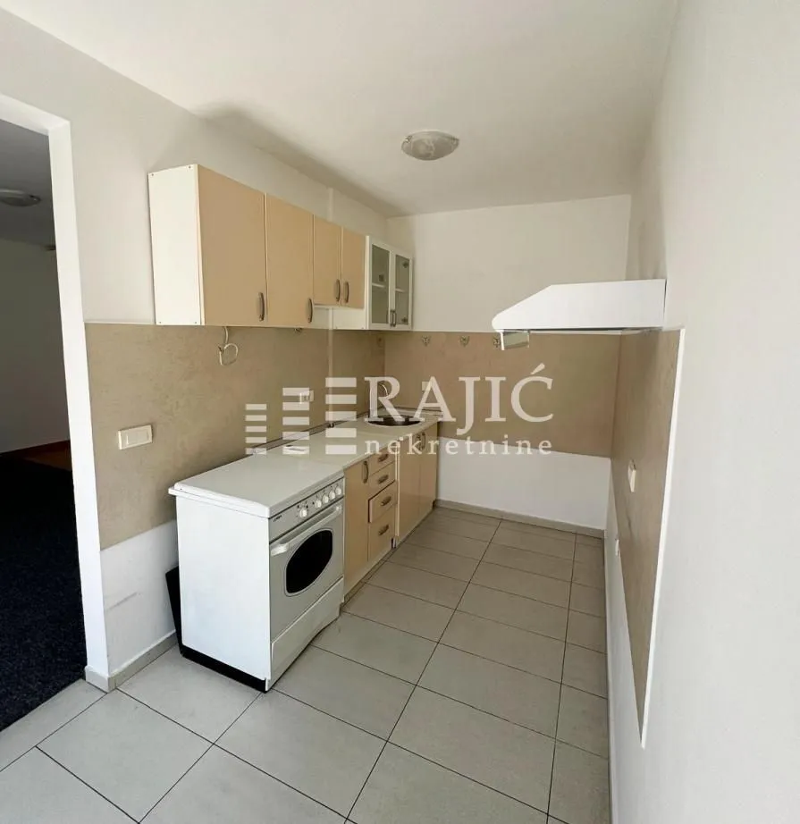 Small kitchen with cabinets and stove.