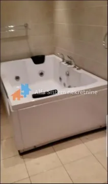 Bathroom with a corner whirlpool bathtub and ceramic tiles. - image 9
