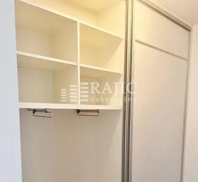 White built-in wardrobe with open shelves and a clothes rail in the room. - image 7