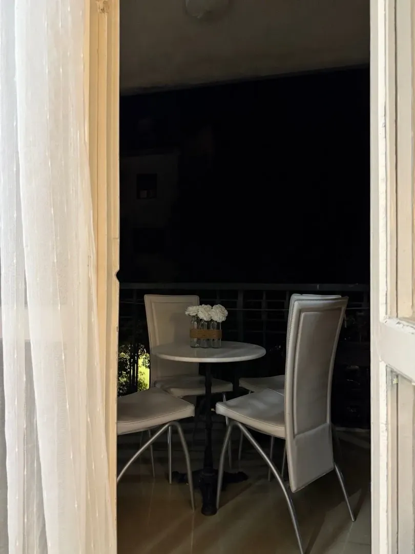 Small table and four chairs on the balcony.