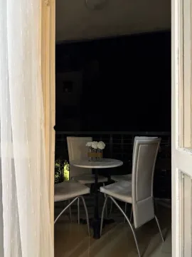 Small table and four chairs on the balcony. - image 5