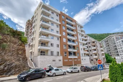 Exterior view of a modern multi-family apartment building with parking in front. - image 11