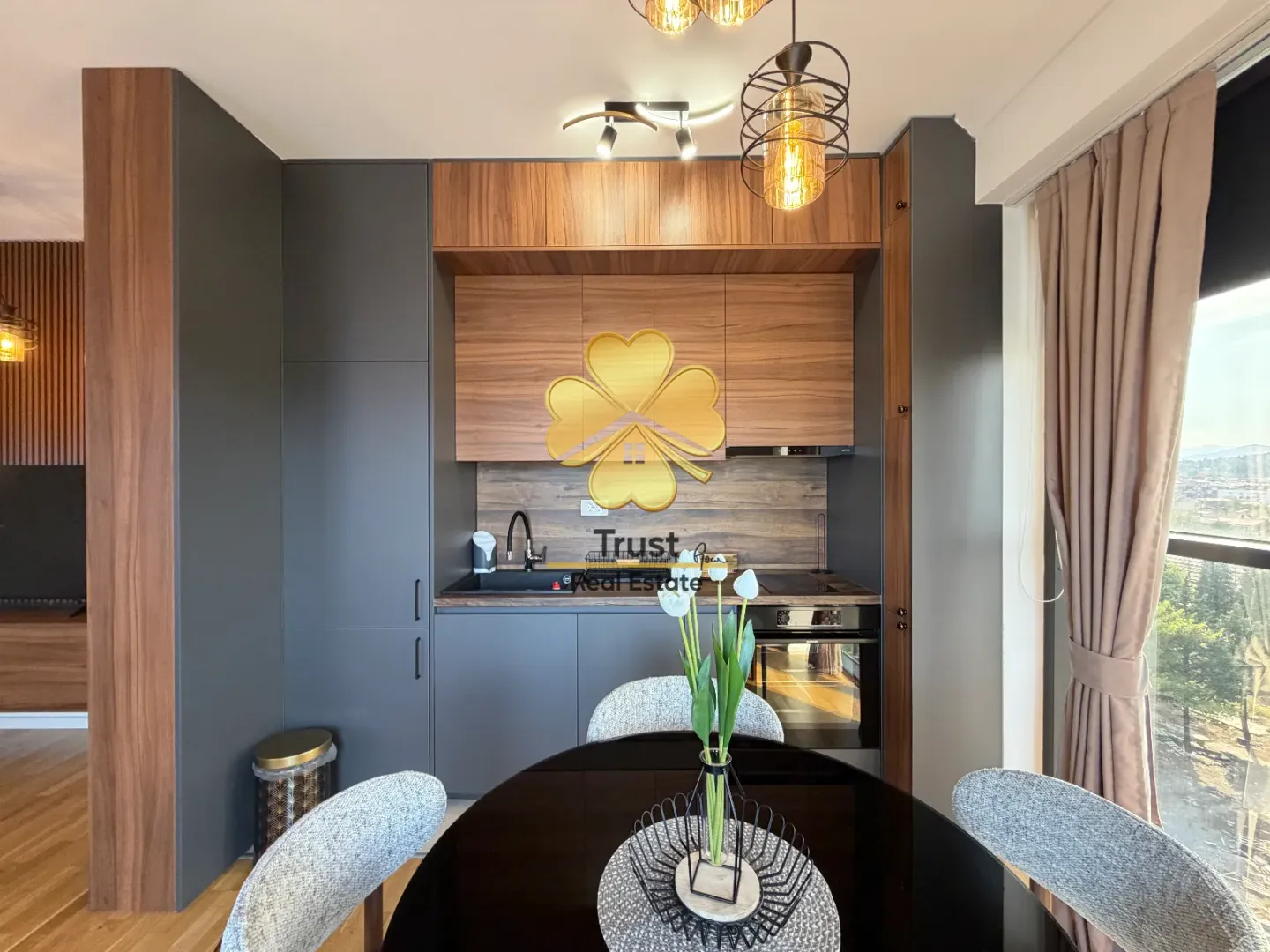 Modern kitchen with dining area and built-in appliances.