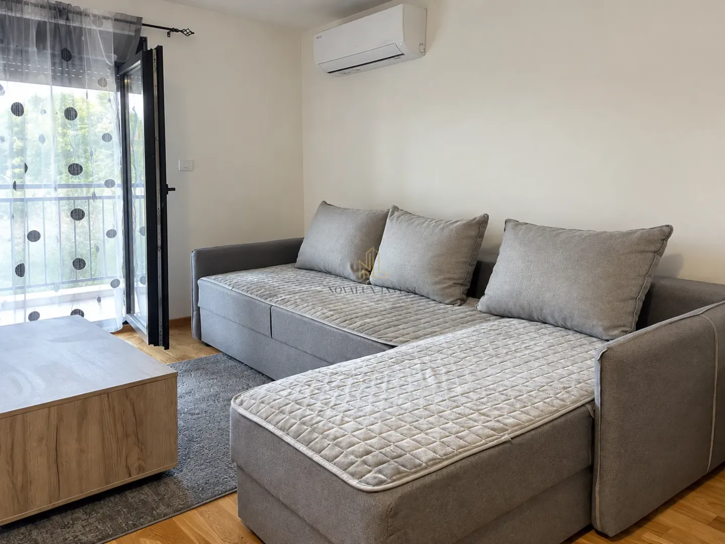 Living room with a gray sectional sofa and access to the terrace.