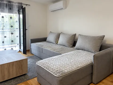 Living room with a gray sectional sofa and access to the terrace. - image 3