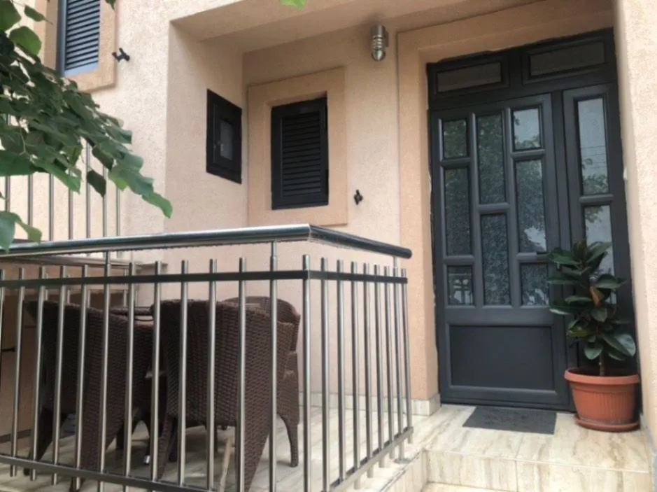 Entrance door with a small terrace in front.