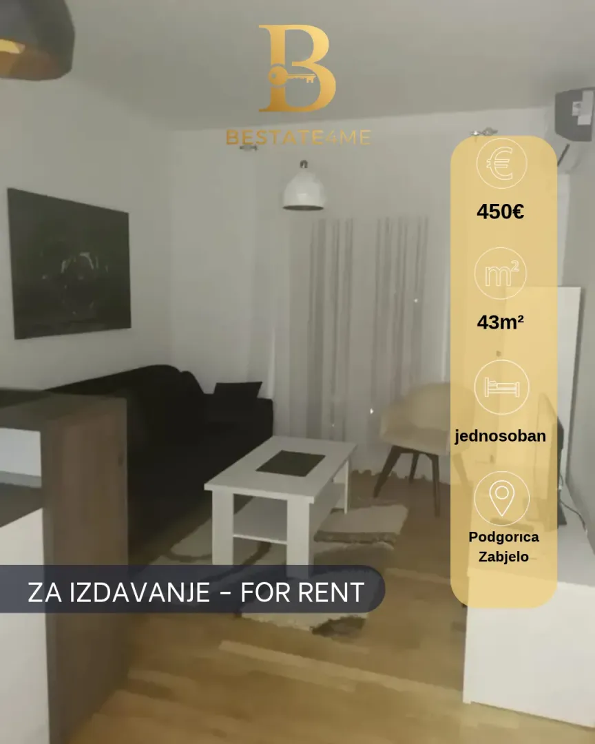 Living room furnished with a sofa and a table.