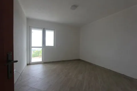 An empty room with light floor tiles and a balcony door. - image 5