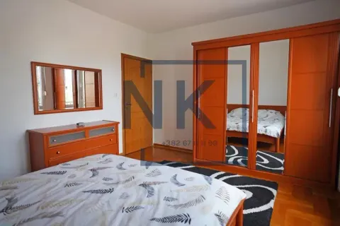 Furnished bedroom with a double bed, large wooden wardrobe, and chest of drawers. - image 4
