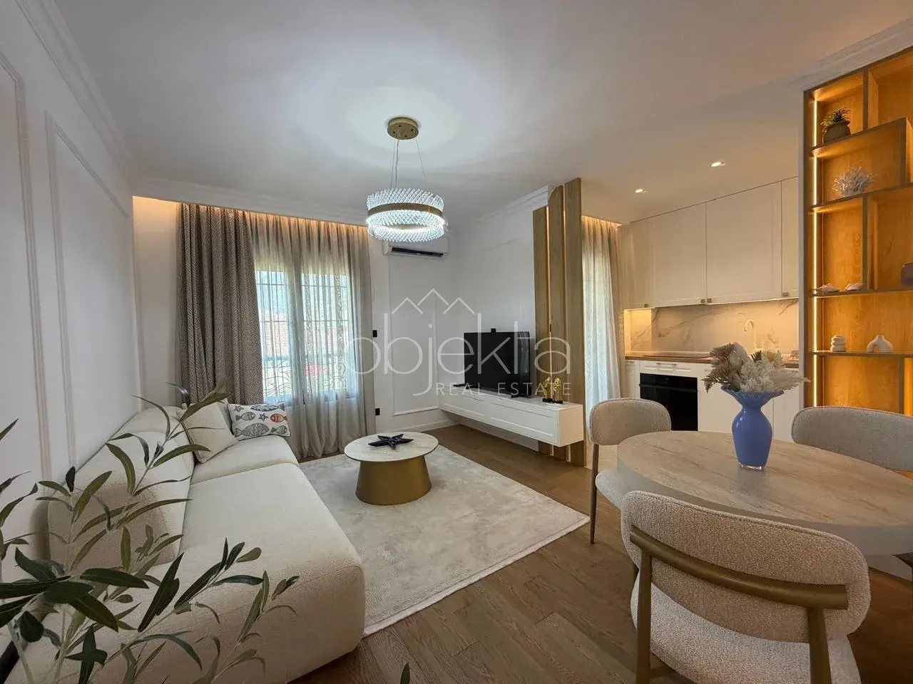 Modern living room with a dining area and an open kitchen.
