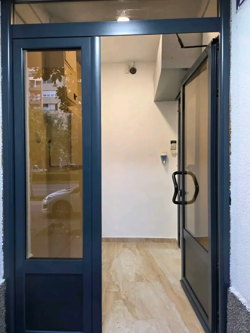 Entrance door of a residential building with glass panels.