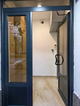 Entrance door of a residential building with glass panels. - image 3