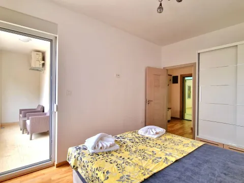 Bedroom with a double bed, wardrobe and access to the terrace. - image 11