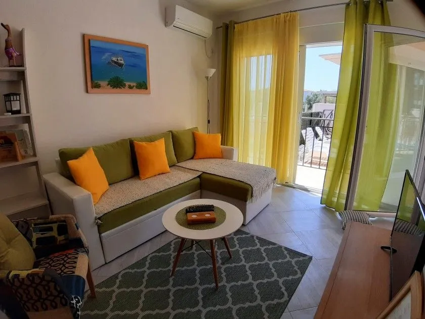 Living room with a sofa, coffee table, and access to the terrace.