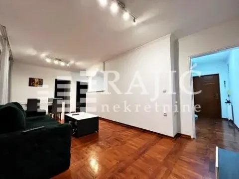 Living room with a sofa and dining area. - image 3