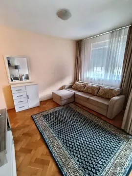 Living room with a sectional sofa, chest of drawers, and a mirror. - image 6