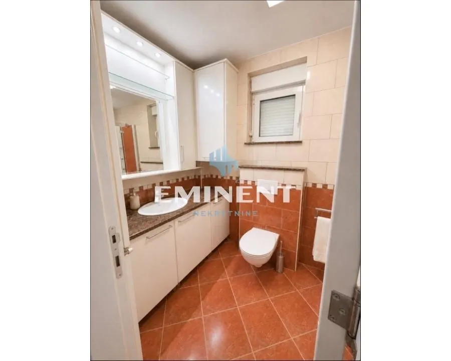 Bathroom with a sink, built-in cabinets, and a toilet.