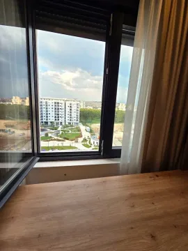 View through the window towards surrounding buildings and courtyard. - image 8