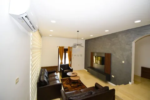 Living room with sofa set, TV, and air conditioning unit. - image 12