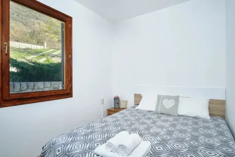 Bright bedroom with a double bed and a window overlooking nature. - image 13