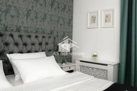 Bedroom with a double bed and patterned wallpaper. - image 17