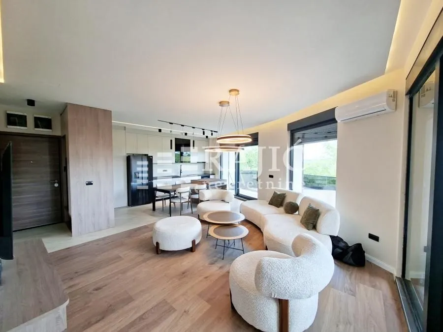 Modern and bright living room connected to the dining area and kitchen.