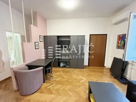 Living room with a dining table and parquet flooring. - image 4