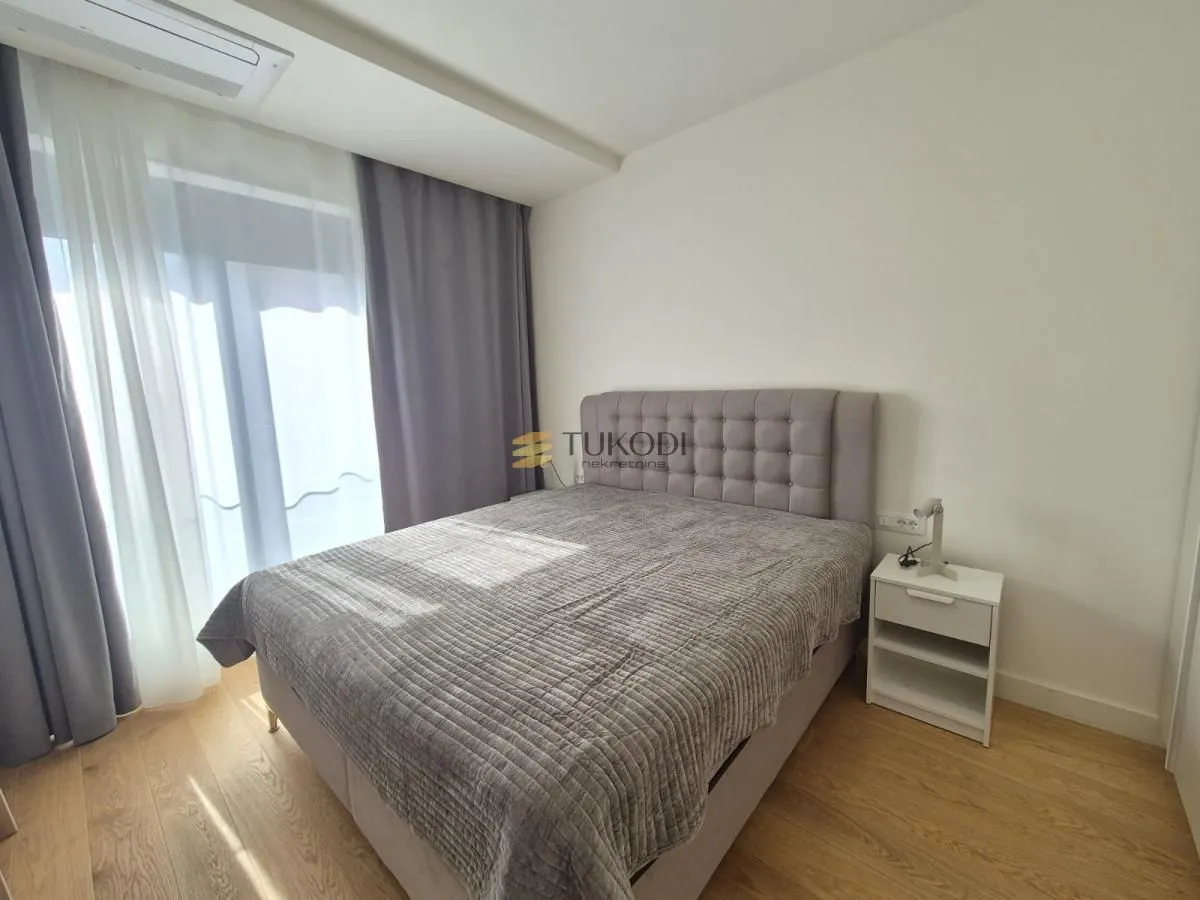 Bedroom with a double bed and a nightstand.