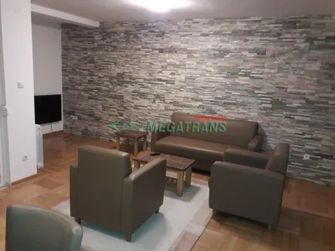 Living room with a sofa set and a decorative stone-clad wall. - image 2