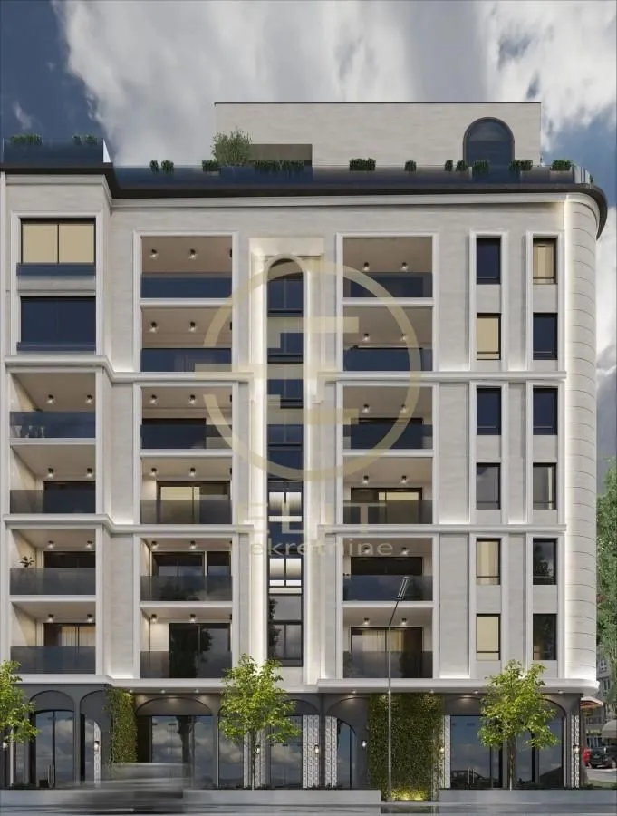 Exterior view of a modern residential building with balconies and a ground floor.