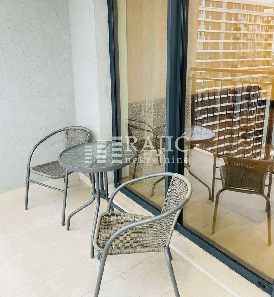 A small balcony with patio furniture.
