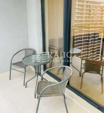A small balcony with patio furniture. - image 10