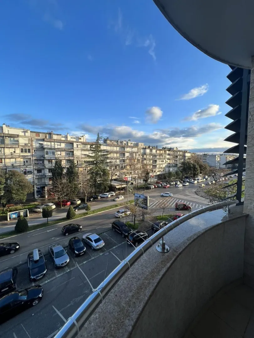 View from the balcony overlooking the street and city landscape.