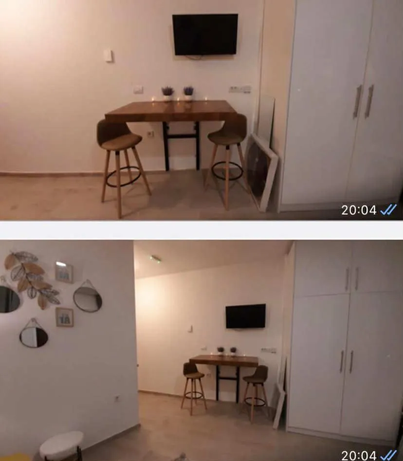 Living room with a dining table and wardrobe.