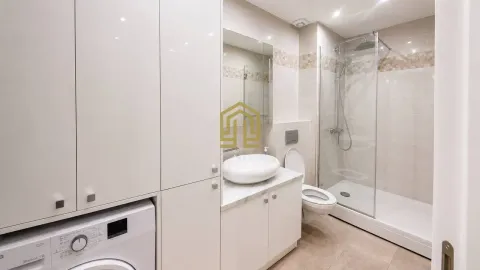 Bright and modern bathroom with a shower cabin and a washing machine. - image 9