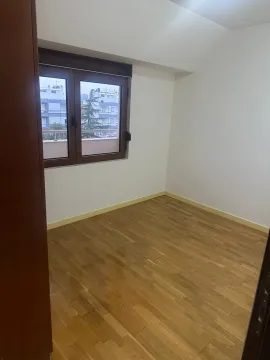 Bright empty room with wooden flooring and a window. - image 14